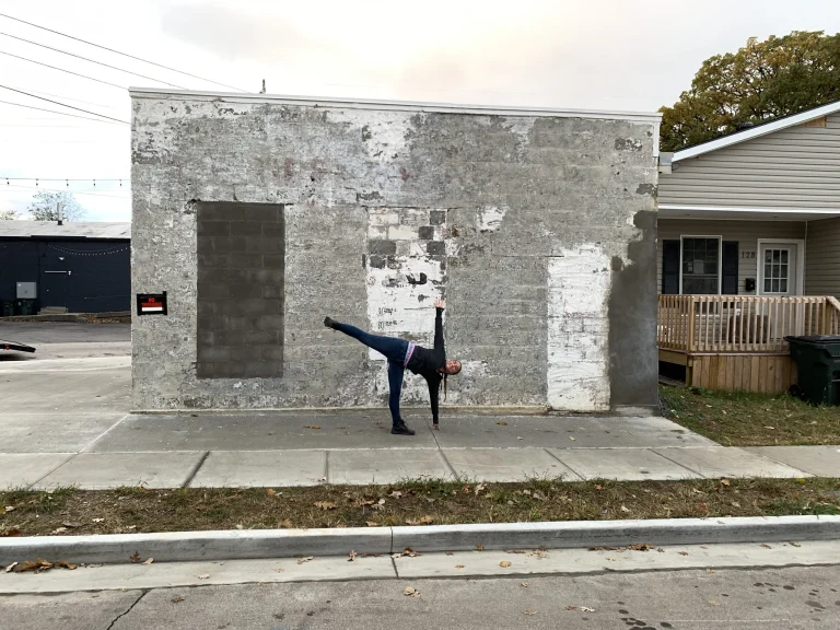 Ivy in half-moon pose outside the studio building before it was painted