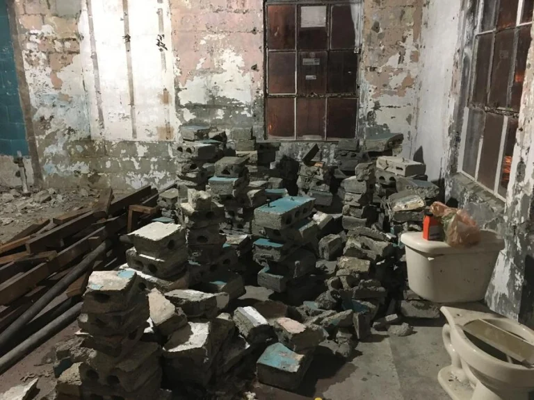Stacked concrete block and salvaged fittings inside the building during the renovation